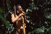 Matis hunter in forest, Javari valley, Amazonia Brazil. NB facial decorations mimic jaguar