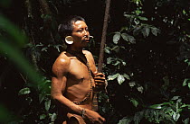 Matis hunter in rainforest with blow pipe, Javari valley, Amazonia Brazil. NB facial decorations mimic jaguar