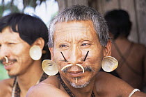 Matis hunter portrait, facial decorations to resemble jaguar, Amazonia, Brazil