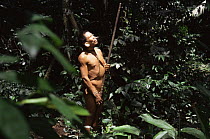 Matis hunter in rainforest, facial decorations to resemble jaguar, Amazonia, Brazil