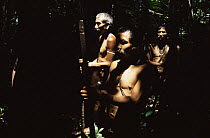Matis hunters in rainforest, facial decorations to resemble jaguar, Amazonia, Brazil