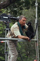 Wildlife cameraman and photographer Nick Gordon beside his pet Black spider monkey 'Pete' (Ateles paniscus paniscus) Amazonia, Brazil