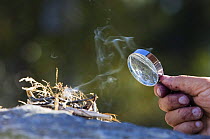 Lighting a fire with a magnifying glass, Norway 2006