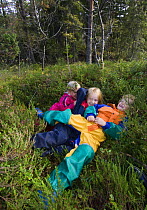 Children in a Norwegian naturbarnehage (nature nursery) playing in the forest, Trondheim, Norway, 2006