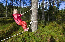 Girl in a Norwegian naturbarnehage (nature nursery) rope walking, Trondheim, Norway 2006