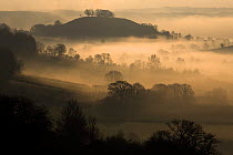 Downham Hill shrouded in winter mist from Coaley Peak on the Cotswold Way, Gloucestershire, England