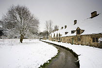 Medieval cottages with a stream at Arlington Row in the winter, Bibury, The Cotswolds, Gloucestershire, England