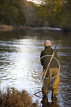 Man fly fishing on the River Usk at the Gliffaes Country House Hotel, Brecon Beacons, Wales