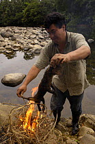 Possum being roasted for food, Mindo Cloud Forest, Ecuador, June 2005