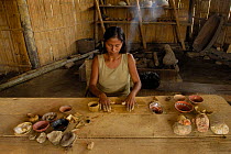 Quechua indian (Ximena Cerda) making coil ceramic bowls from clay dug out from the upper reaches of the Napo river, Ecuador, June 2005