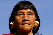 Huaorani indian woman (mother of Moi Enomenga, the leader of Quehueire Ono community and an influencial Huaorani leader) with balsa earplugs.  Amazon rainforest, Yasuni NP, Ecuador, July 2005