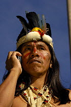 Huaorani indian man on his mobile phone, Moi Enomenga, leader of the Quehueire Ono community and an influencial Huaorani leader, in Quito for a protest march against Petrobras, a Brazilian oil company...