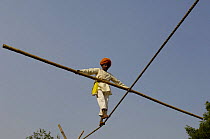 Tight rope walker performing at the Pushkar camel and livestock fair, which takes place in the Hindu month of Kartik (October / November) ten days after Diwali (Festival of Lights). Pushkar, Rajasthan...