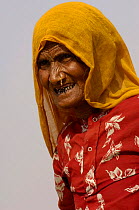 Woman at the Pushkar camel and livestock fair, which takes place in the Hindu month of Kartik (October / November) ten days after Diwali (Festival of Lights). Pushkar, Rajasthan, India, October 2006