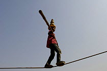 Young tight rope walker performing at the Pushkar camel and livestock fair, which takes place in the Hindu month of Kartik (October / November) ten days after Diwali (Festival of Lights). Pushkar, Raj...