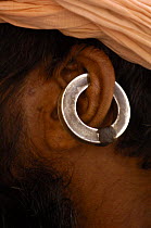 Close up of traditional earring of a Gorakhnathi Yogi / holy man from Mahayogi Machhendra Nath Temple in Pushkar, Rajasthan, India, October 2006