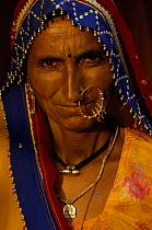 Rajasthani woman with nose ring   jewelry Pushkar camel and livestock fair, Pushkar, Rajasthan, India, October 2006