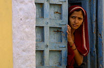 Woman in doorway of traditional sandstone house of Jaisalmer. Rajasthan, India, 2006