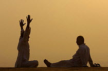 Men practising yoga in the early morning on the ridge near the Mehrangarh Fort in Jodhpur. Rajasthan, India 2006