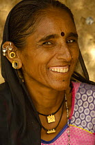Rabari woman wearing everyday dress and jewellery with ornate earrings, Rann of Kutch, Gujarat, India, November 2006
