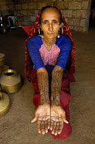 Rabari woman of the Sorathi subgroup found in and around the Gir Forest National Park, Gujarat, India. 2006, with ornate tattoos on her skin.