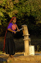 Rabari woman of the Sorathi subgroup found in and around the Gir Forest National Park, Gujarat, India. 2006, drawing water from the village well.