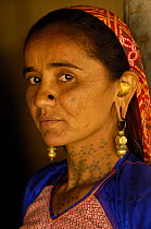 Rabari woman of the Sorathi subgroup found in and around the Gir Forest National Park, Gujarat, India 2006. Note ornate ear rings and skin tatoos