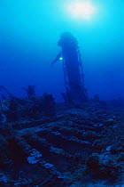 Diver explores funnel on the shipwreck of the Japanese WWII destroyer, 'Shotan Maru', Chuuk / Truk lagoon, Chuuk islands, pacific ocean