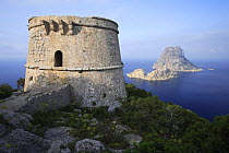Es Savinar tower with  Small barren islands of Es Vedrá in background, Ibiza, Balearic Islands, Spain