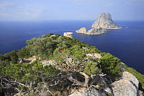Coastal view from Ibiza, with Es Savinar tower and  small barren islands of Es Vedrá, Balearic Islands, Spain