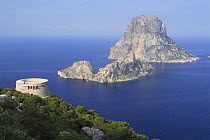 Coastal view from Ibiza, with Es Savinar tower and  Small barren islands of Es Vedrá, Balearic Islands, Spain