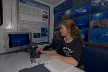 Susan Sobtzik working on her days's research onboard the Undersea Explorer, Queensland, Australia, 2006