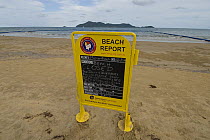 Beach report board infront of stinger-resistant enclosure, warning people not to swim because of Irukandji and Box Jellyfish, Queensland, Australia  2006