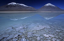 Extinct volcano Licancabur (on right) reflected in Laguna Verde, Altiplano, Bolivia