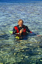 Sir David Attenborough in scuba diving equipment on location for BBC television series "Private Life of Plants", early 1990s. Heron Island, Great Barrier Reef, Australia