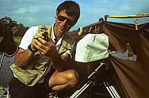 Camerman Michael Pitts with Wattled jacana (Jacana jacana) filming on location at Chagres river, Panama, filming for BBC television series 'Trials of Life', 1991/1992