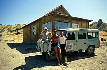 Nigel Marven, Martin Saunders and driver with owl {Bubo sp} beside BBC NHU vehicle, on location in Badkhyz, Turkmenistan, filming for television series "Realms of the Russian Bear"