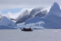 Tourists on boat among icebergs. Laurie Island, South Orkney Isles, Antarctica. January 2007.