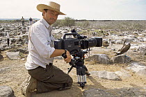 Cameraman Paul Stewart filming nesting Blue footed boobies {Sula nebouxii} Espanola Is, Galapagos, 2006