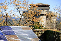 Solar panels with castle in background, Granadilla, Caceres, Spain