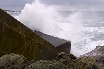 Wave breaking on wave powered energy generation station, Islay, Argyll, Scotland, UK