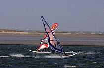 Windsurfers on a windy Marine Lake with Wind Turbines in the background, Wirral, March 2007