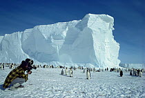 Cameraman Doug Allan filming Emperor penguin colony, Antarctica, for Life in the Freezer