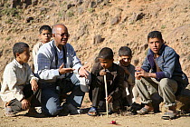 Man teaching boys about the environment, Wadi Qarad, Socotra Island, Yemen