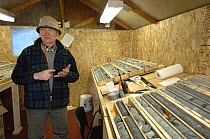 Geologist studying / explaining mineral cores, Northwest Territories, Canada March 2007