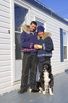 Young couple wearing winter gear and inuit style anoraks with fur, Yellowknife, Northwest Territories, Canada March 2007