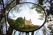 Reflection of Torre de Riu Castle in roadside mirror, La Molina, Puigcerda, Barcelona, Spain