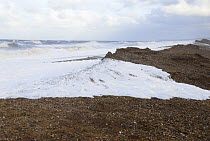 Sea water breaching shingle bank during high spring tides, Cley, Norfolk, UK, March 2007