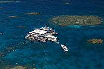 Aerial view of the Great Barrier Reef with tourist dive boats. Agincourt Reefs, off Port Douglas, Queensland.