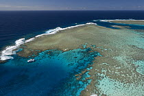 Aerial view of the Great Barrier Reef with tourist dive boat. Agincourt Reefs, off Port Douglas, Queensland, Australia
